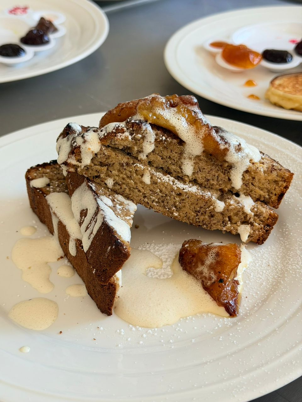 Banana bread stack with caramelized fruit and crème anglaise